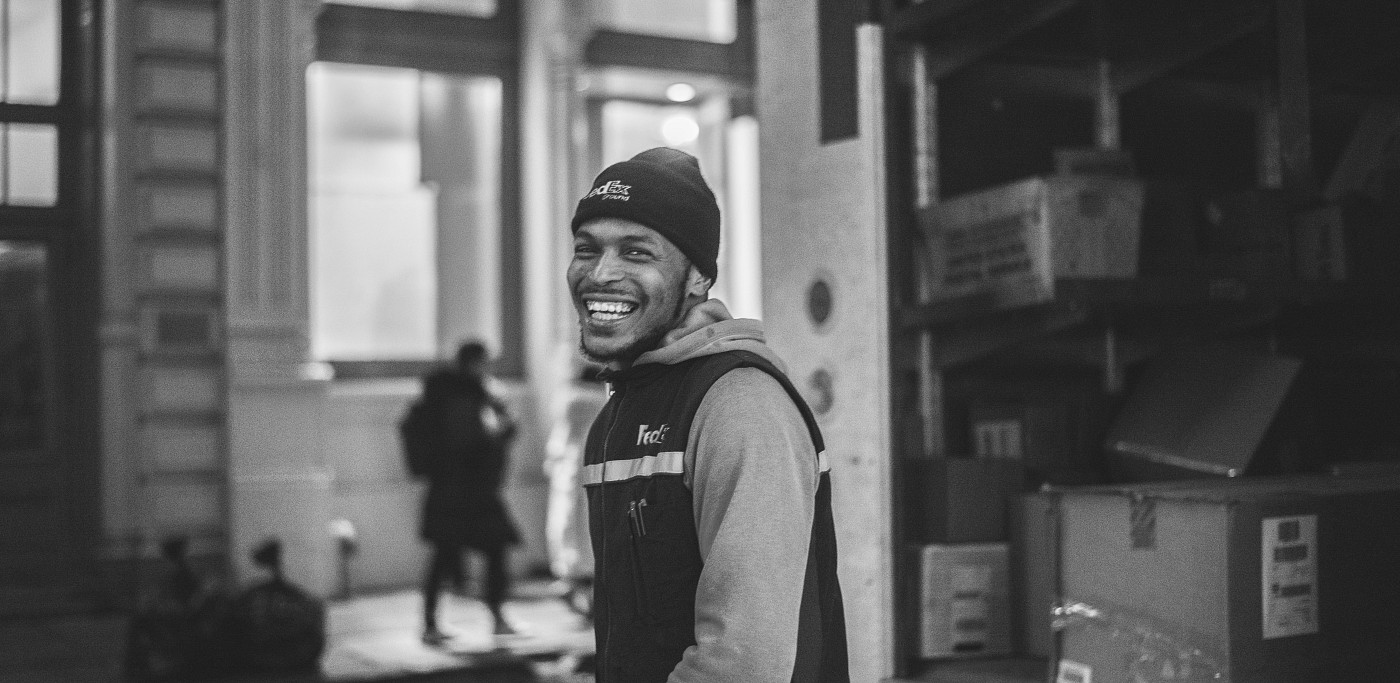 Man smiling in front of delivery truck